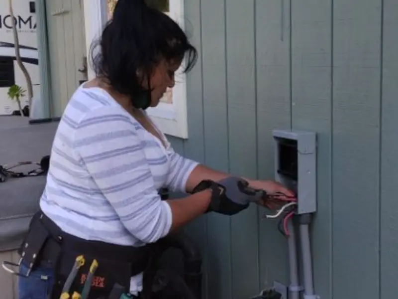 Licensed electrician wiring an exterior subpanel in La Follette