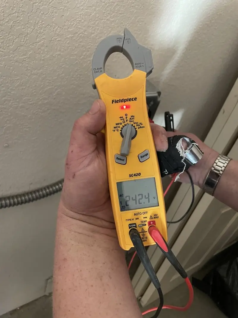 Voltage testing with clamp meter during Outlet Installation in La Follette
